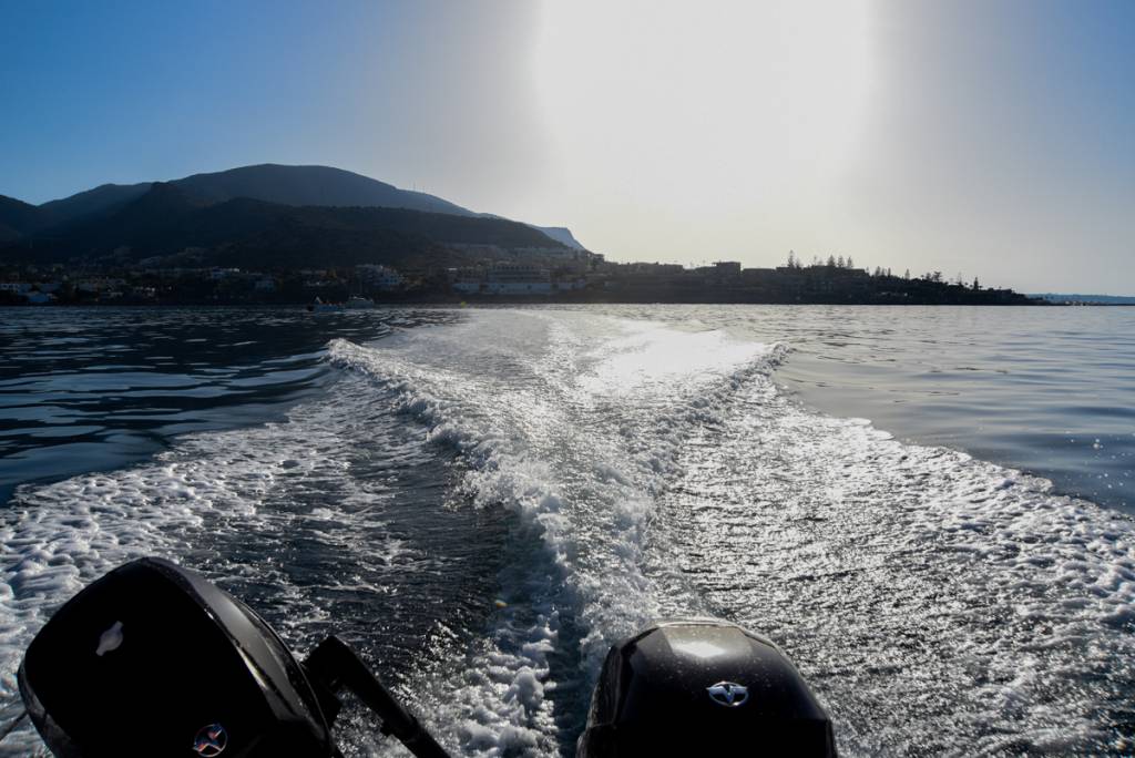 Powerful Tohatsu engine creating whitewater trails as the boat sails near Malia, Crete - perfect for those looking to rend and boat on a private adventure.
