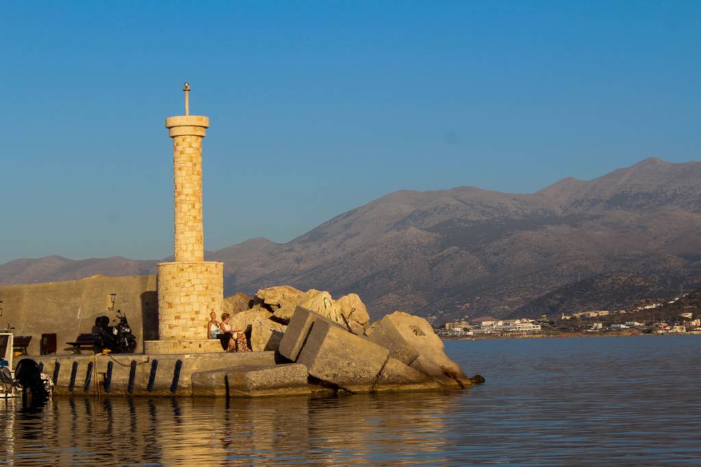 Lighthouse at the entrance of Hersonissos port, Crete, guiding ships into the harbor.