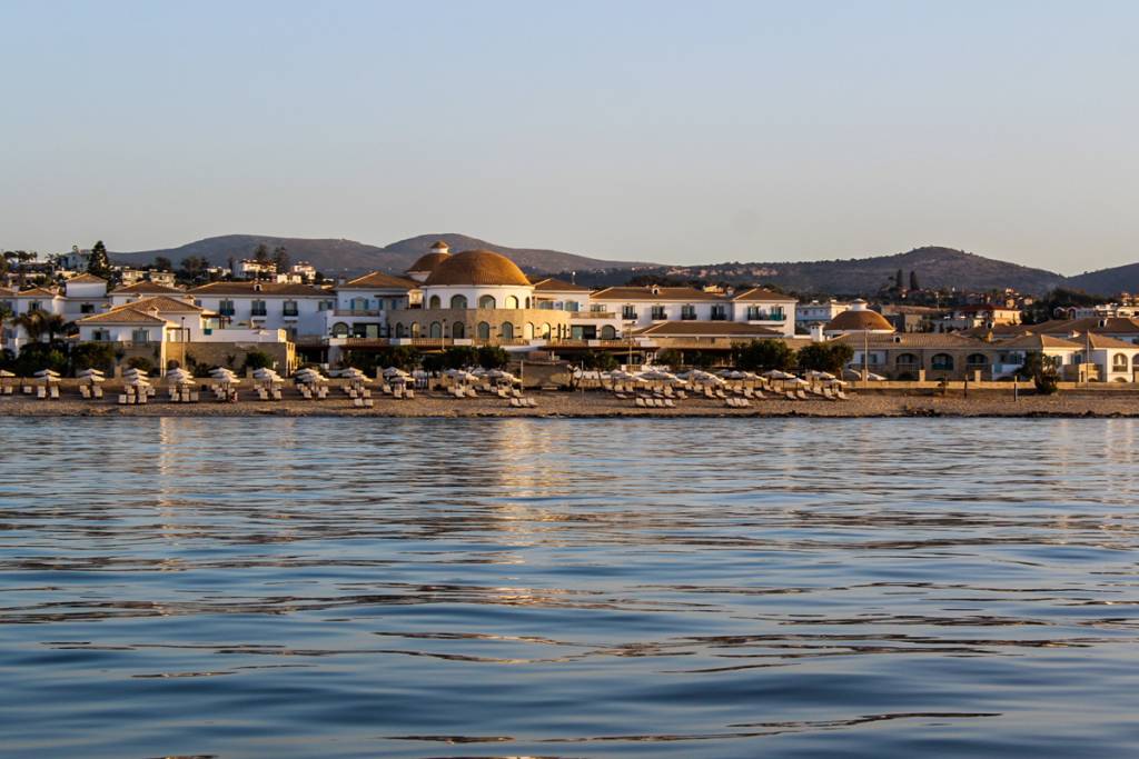 Coastal view from the sea near a luxury hotel in Anissaras, Crete, showcasing the beautiful landscape.