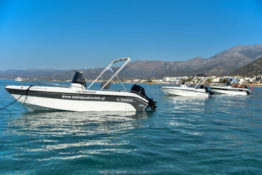 Brand new fleet of rental boats anchored in the calm waters of Stalis Bay, Crete - Perfect for a relaxing boat trip in Crete.